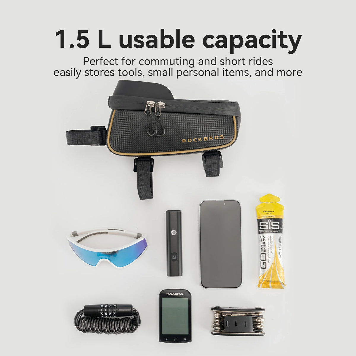 A black bicycle bag with gold trim and black straps is displayed on a light gray background with marketing text reading '1.5 L usable capacity' and various small accessories arranged below it, including sunglasses, a power bank, a phone, a tube, a helmet, a GPS device, and a coiled strap.