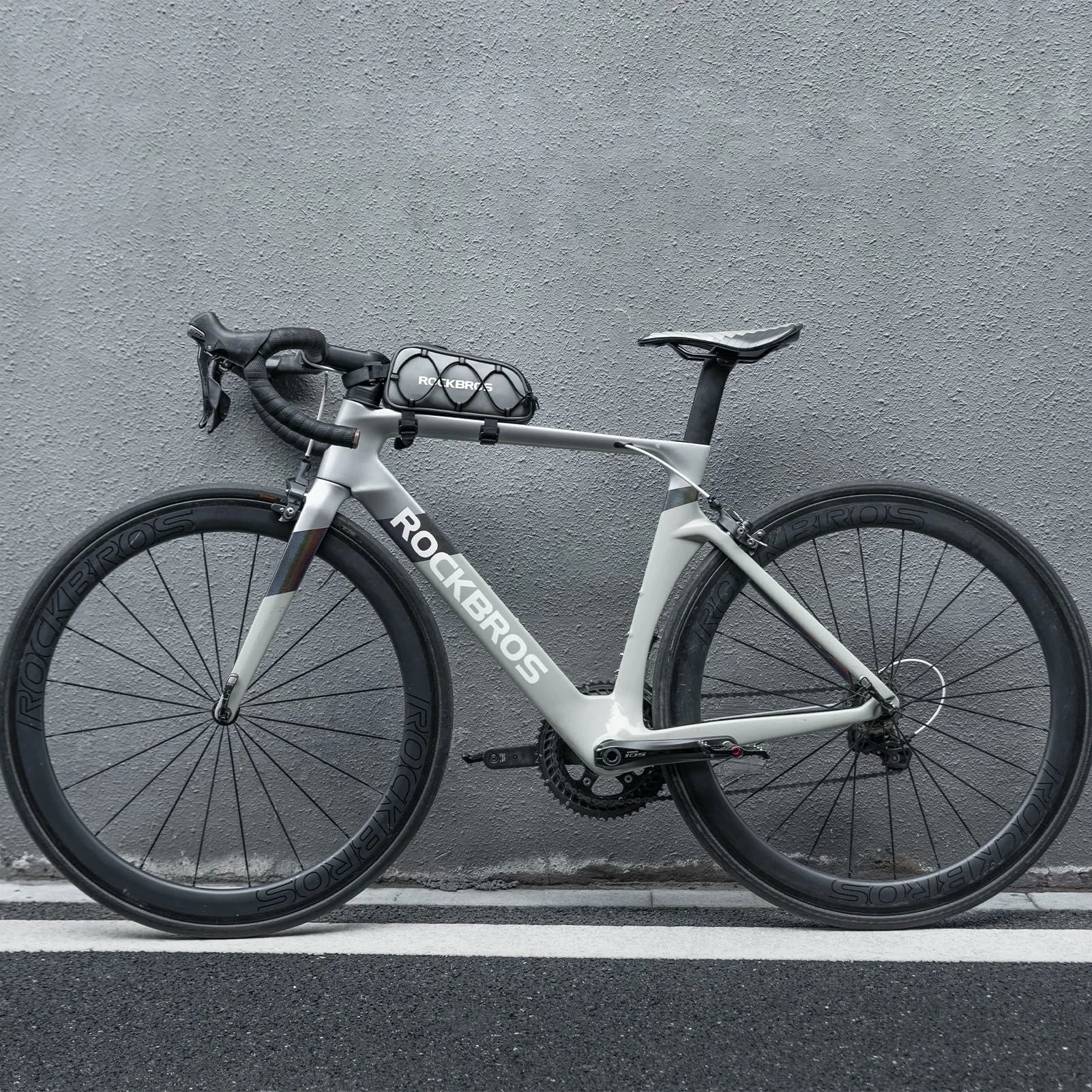White bicycle with 'ROCKBROS' branding against a gray wall #color_silver