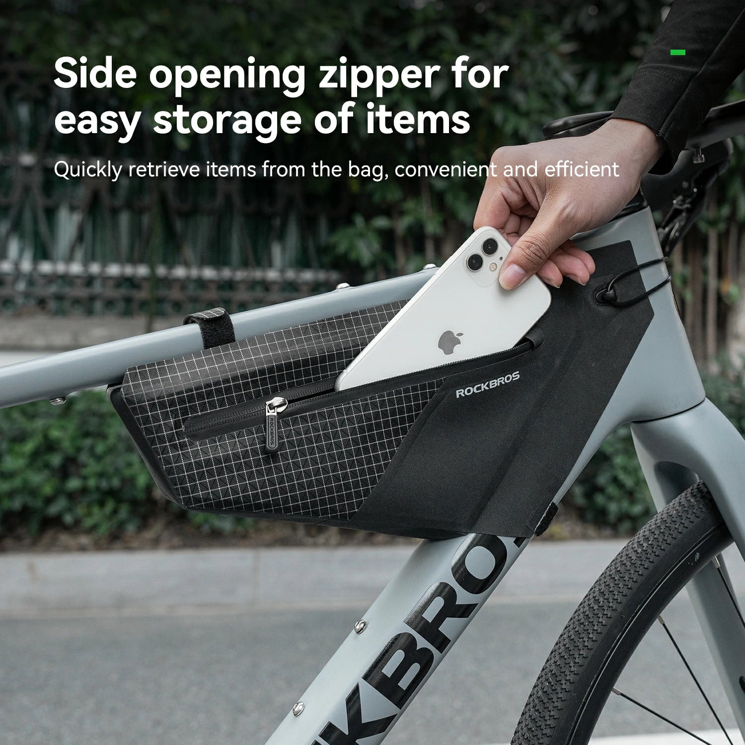 Bicycle frame bag with side opening zipper, showing a hand retrieving an item.
