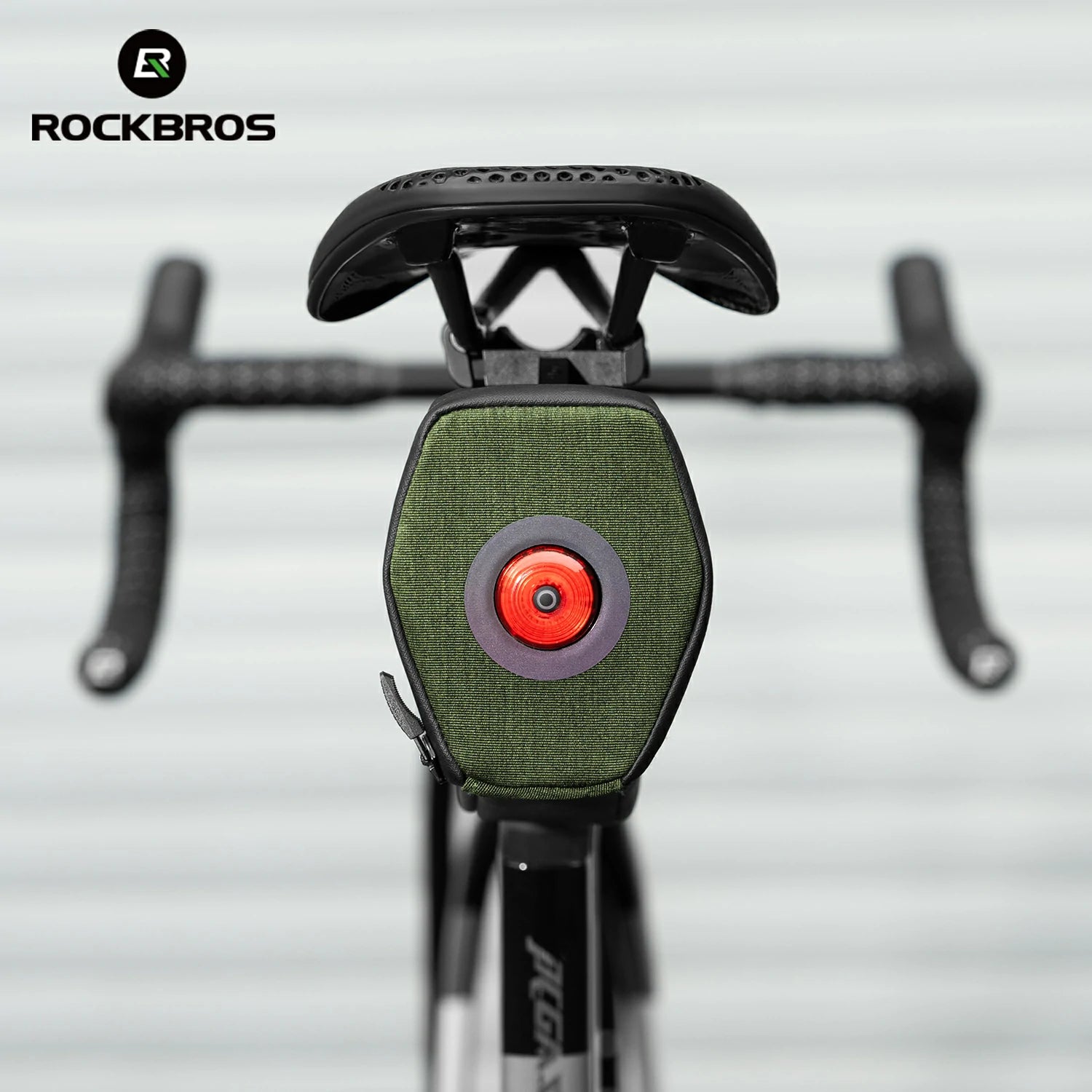 Close-up of a bicycle with a green light and red center, branded with RockBros.
