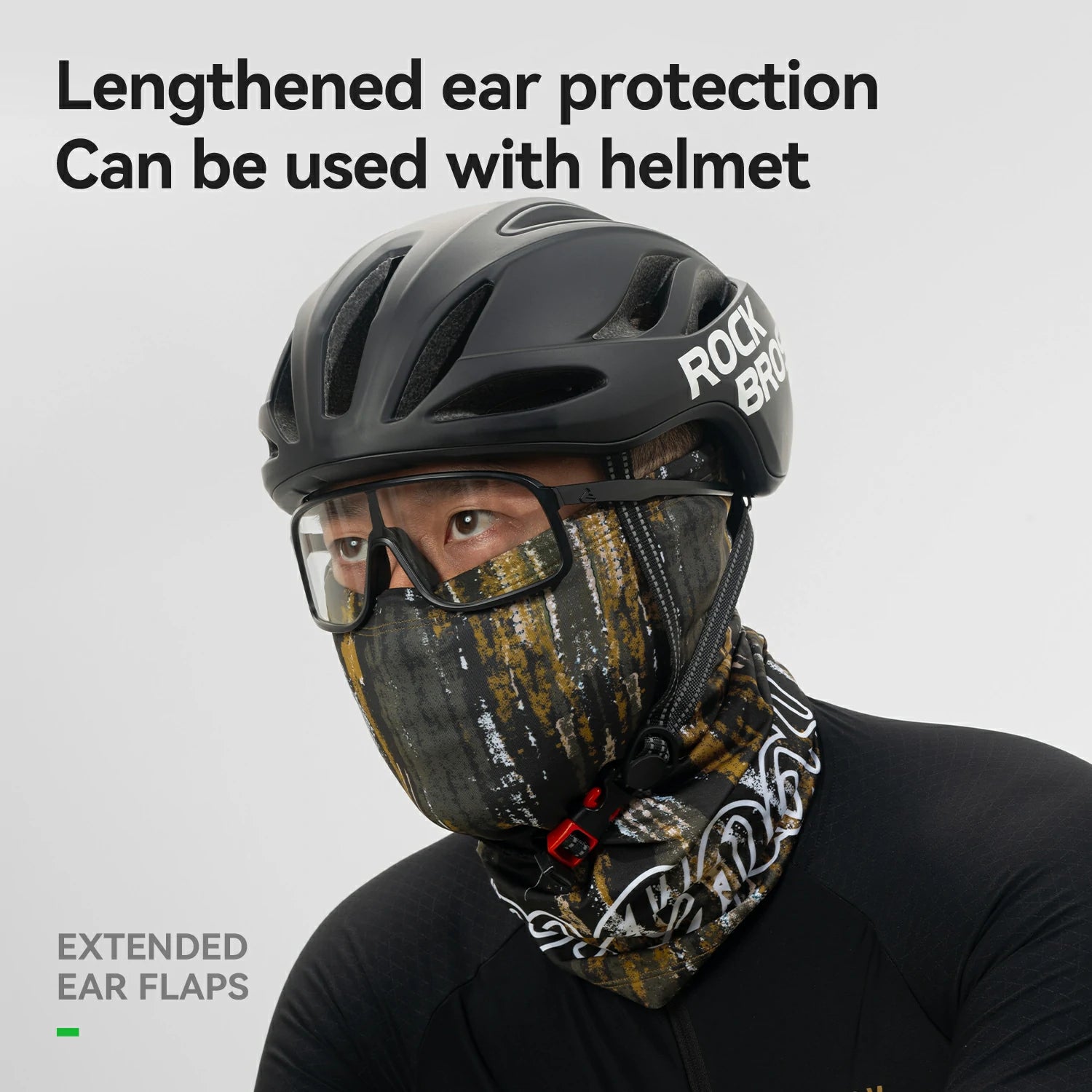 Person wearing a helmet with extended ear flaps and a face mask on a gray background