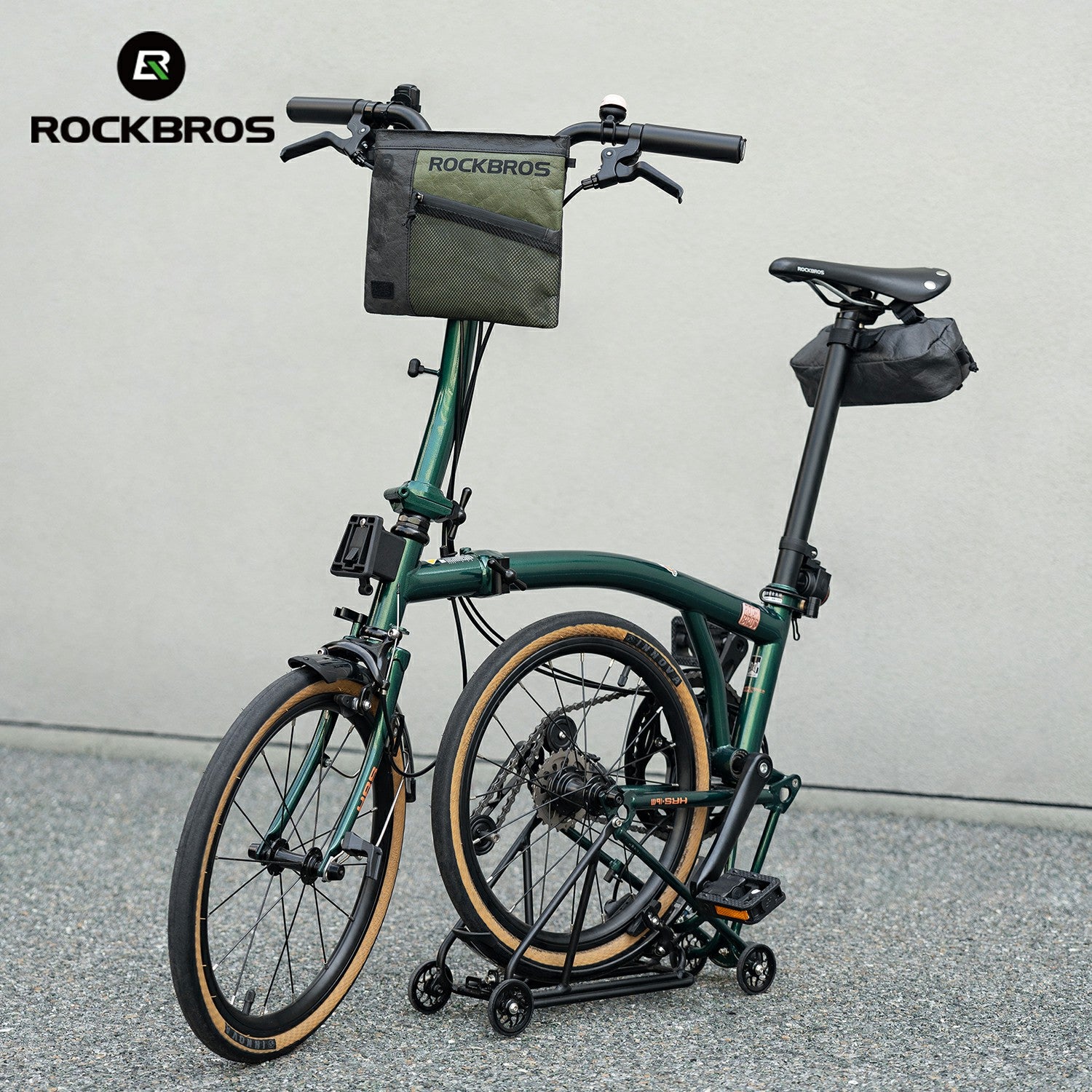 Green folding bike with storage bags on a gray background, featuring the RockBros brand.