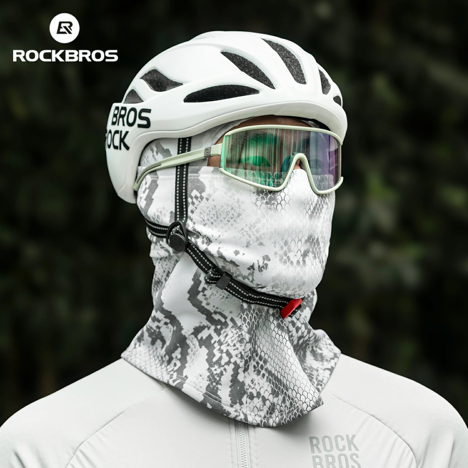 Person wearing a white helmet, goggles, and camouflage neck gaiter with RockBros branding. #color_Serpentine gray