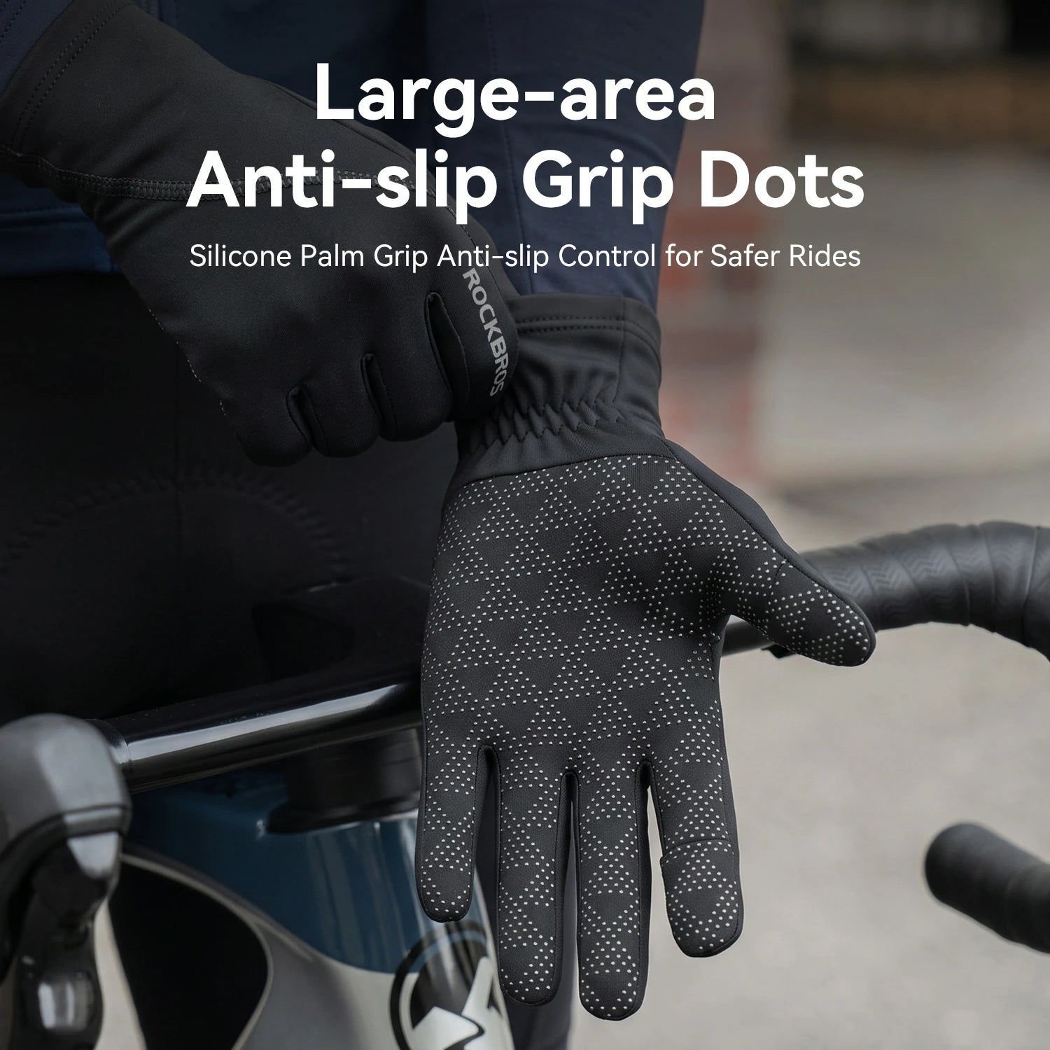 Black cycling gloves with raised anti-slip grip dots, shown on a rider's hand near bicycle handlebars. White text reads 'Large-area Anti-slip Grip Dots' and 'Silicone Palm Grip Anti-slip Control for Safer Rides.