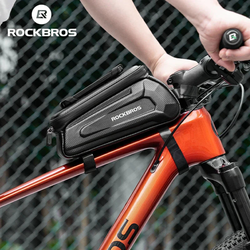 RockBros bike handlebar bag attached to an orange bicycle with a blurred background