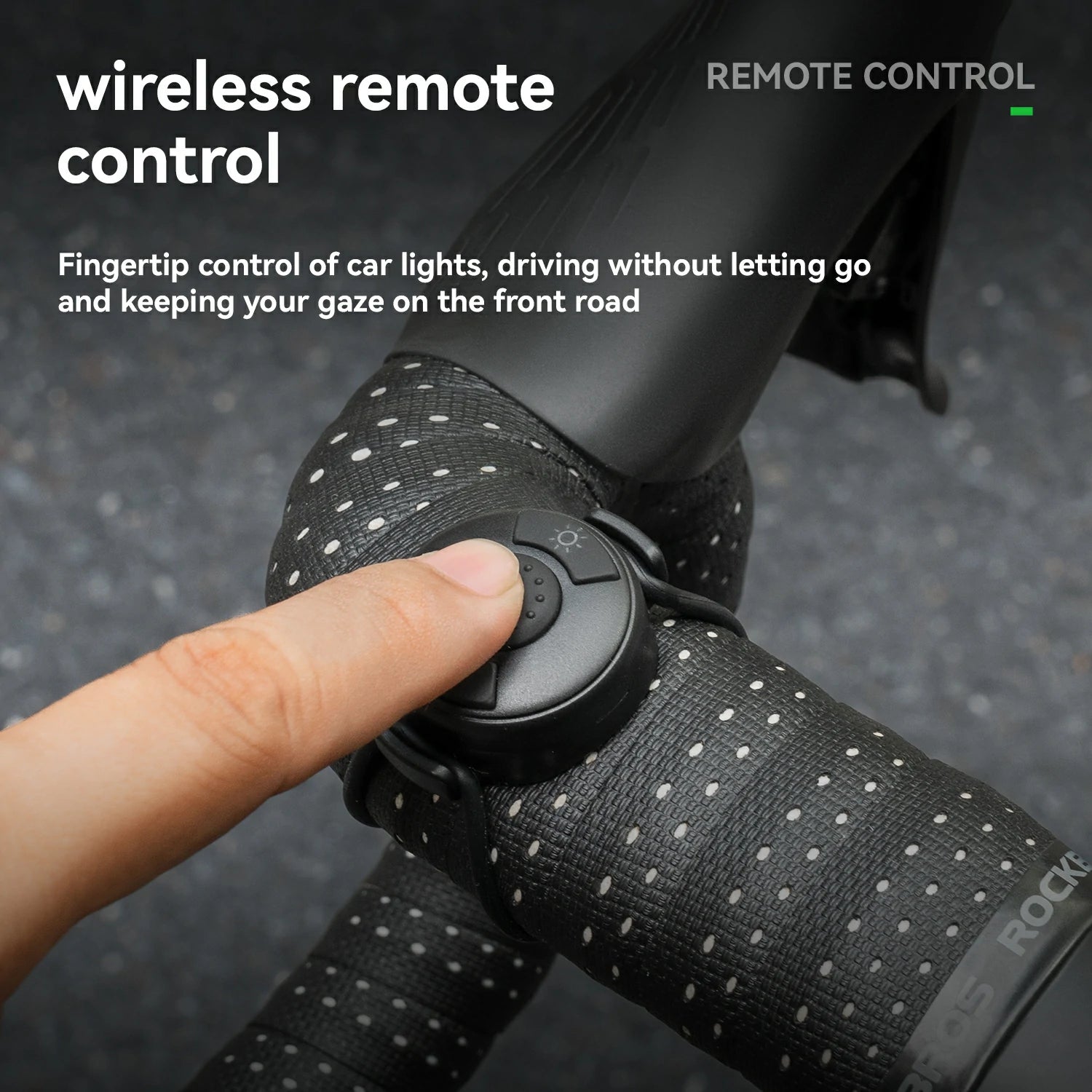 Close-up of a finger pressing a small black wireless remote control mounted on a bicycle handlebar. The handlebars are wrapped in black textured tape with small white dots, and text on the image reads 'wireless remote control' and 'REMOTE CONTROL'. #Color_Remote Control Version