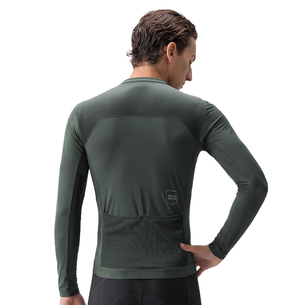 A man shown from the back wearing a dark green long-sleeve athletic compression shirt with a textured back panel and a small shield logo near the lower back, against a plain white background. #Color_Gray