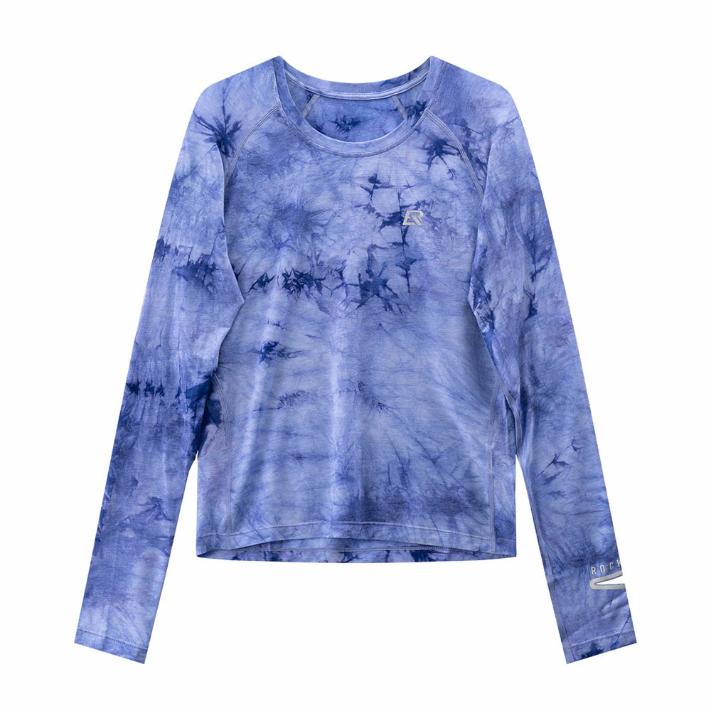 A long-sleeve crewneck athletic top featuring a blue and purple tie-dye pattern, displayed flat against a solid white background. #Color_Purple