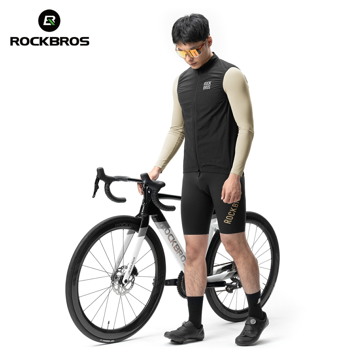 Person wearing a black cycling outfit with a RockBros bike on a white background