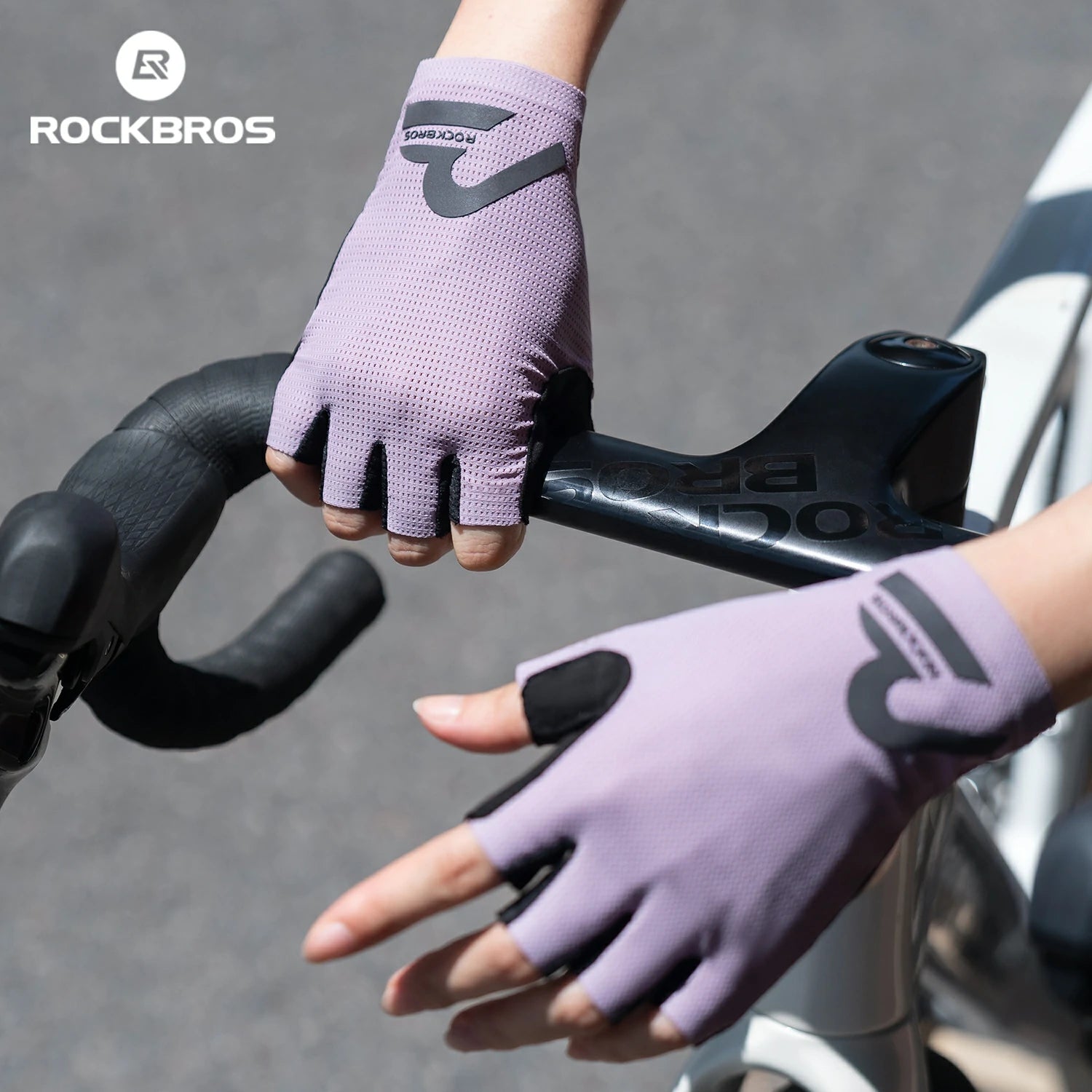 Purple cycling gloves with 'RockBros' branding on a bike handlebar. #color_purple