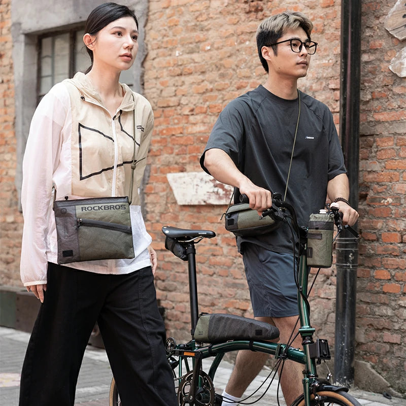 Two people with bicycles and bags in an urban setting