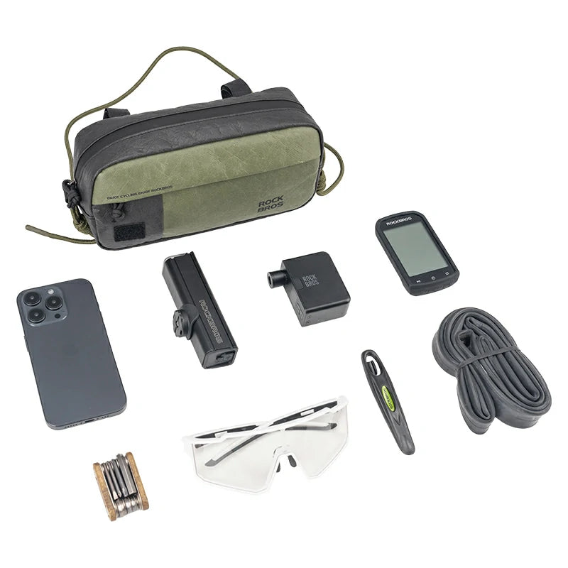 Collection of travel or outdoor gear including a phone, camera, sunglasses, and a bag on a white background.