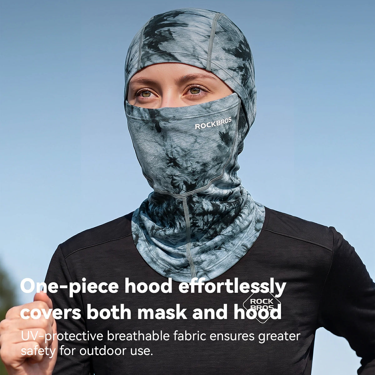 A person wearing a one-piece hooded face mask in a gray and blue camouflage pattern, with text overlay describing its features. The brand name ROCKBROS is visible on the forehead of the mask.