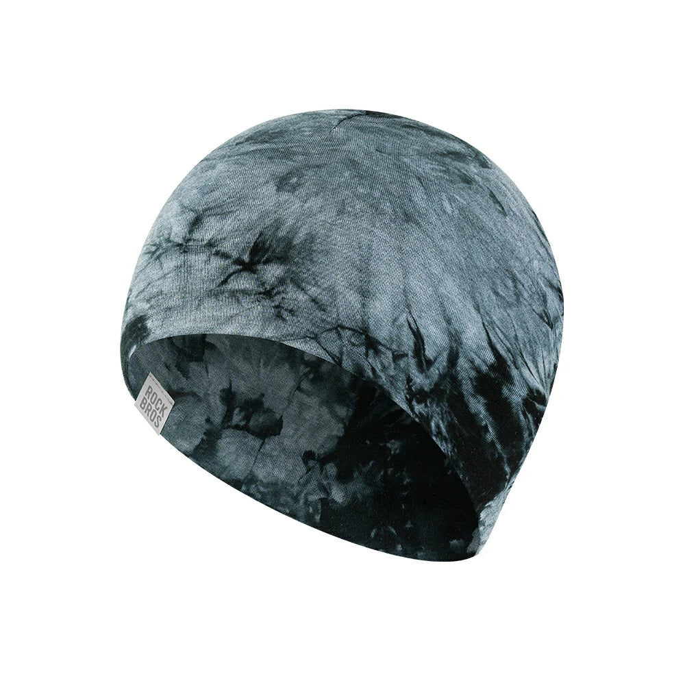A fabric beanie hat with a dark slate blue and black tie-dye pattern, shown on a plain white background. #Color_Gray