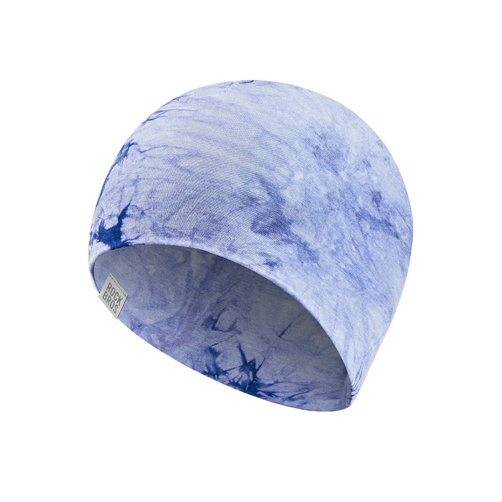 A fabric beanie hat featuring a blue and white tie-dye pattern, shown on a plain white background. #Color_Blue
