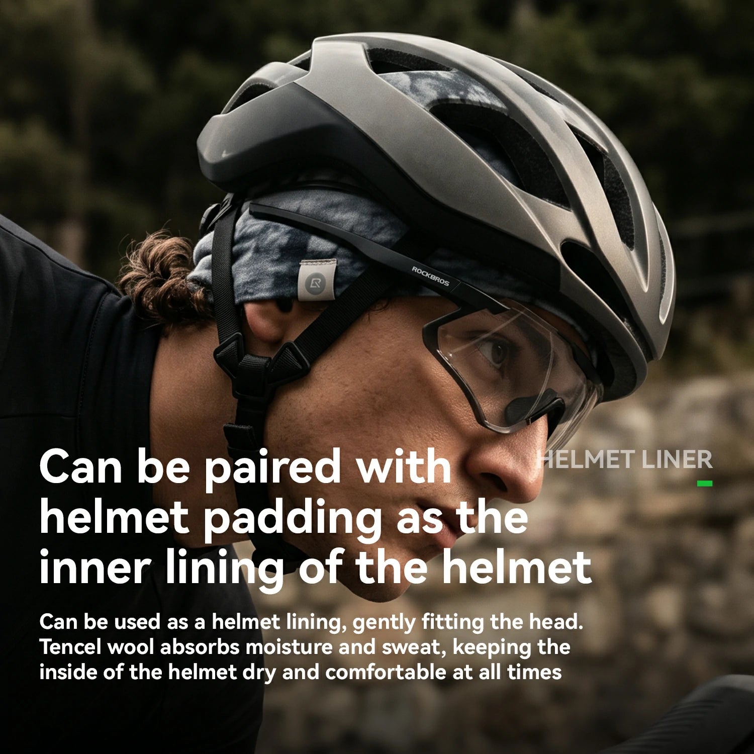 Close-up of a person wearing a matte black bicycle helmet with a patterned headband and clear visor, outdoors. White text overlays explain that the helmet liner can be paired with helmet padding and used as a helmet lining.