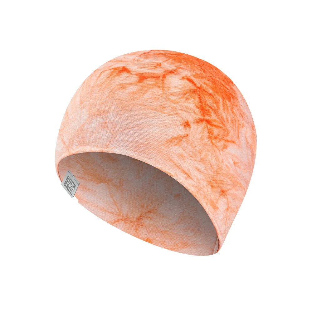A knit beanie hat featuring a light peach and orange marbled pattern, shown on a solid white background. #Color_Orange