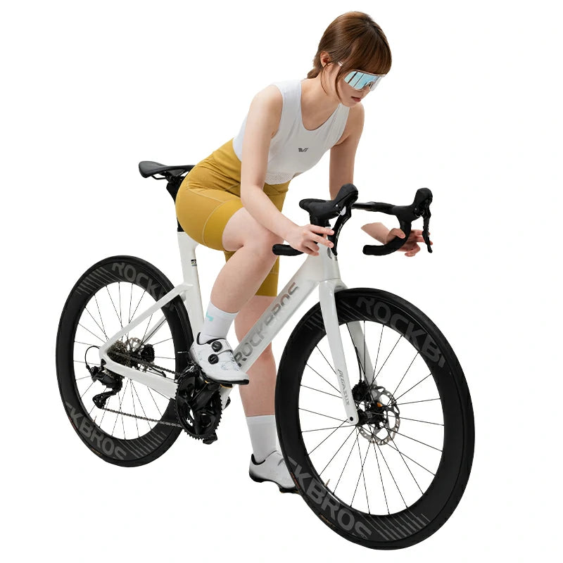 Woman sitting on a white bicycle with black tires on a white background #color_Yellow