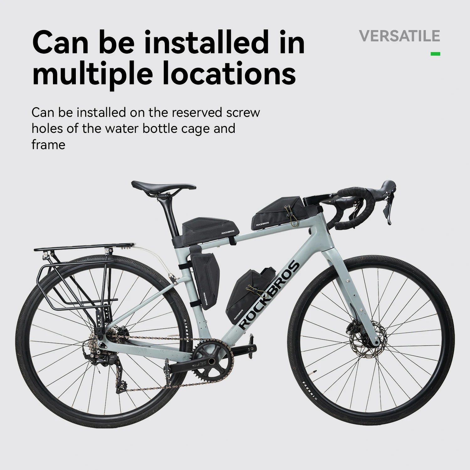 A light gray Rockros road bicycle shown on a pale gray background with marketing text stating it can be installed in multiple locations on the bottle cage and frame.