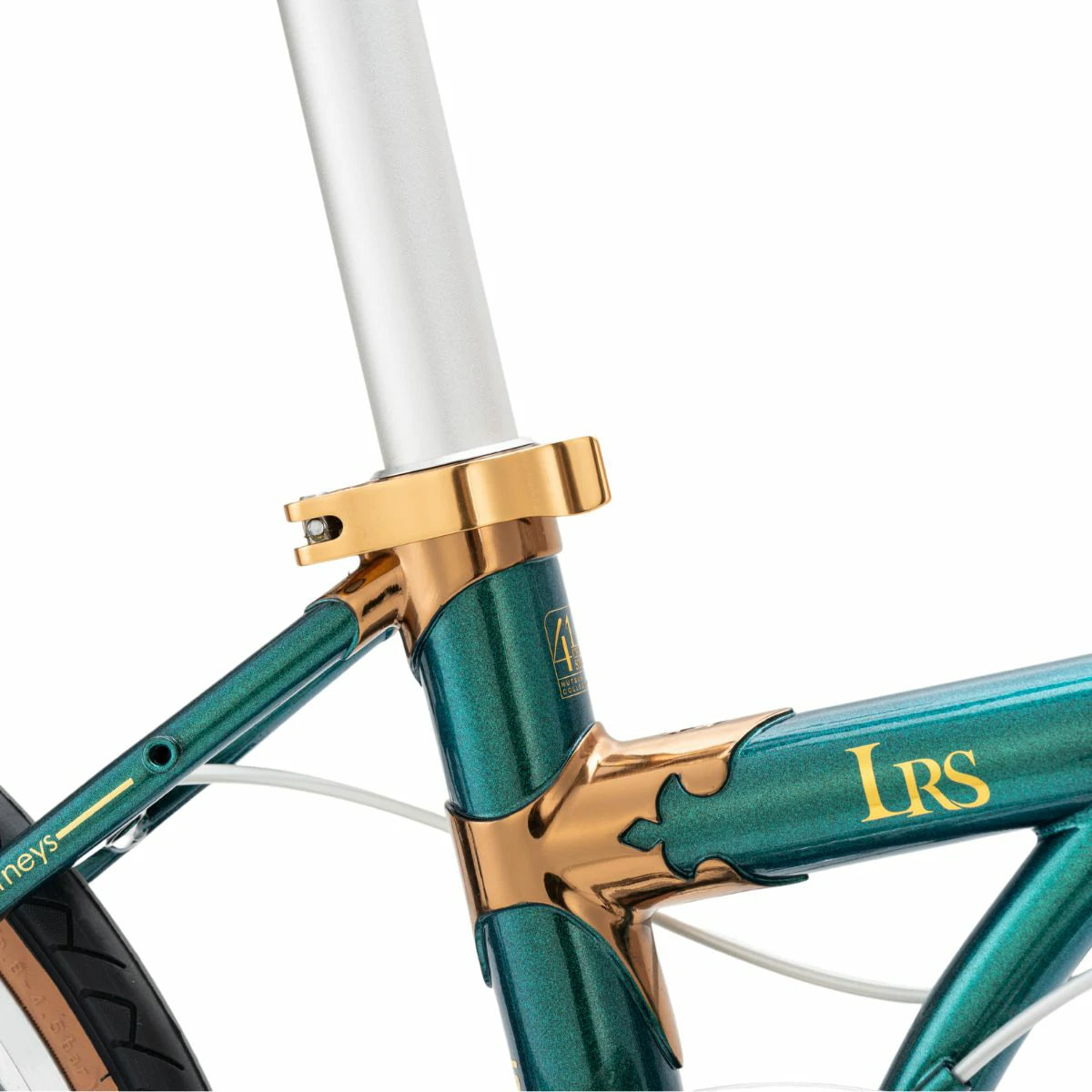 Close-up of a bicycle frame with gold accents and 'LRS' branding on a white background #Color_Green