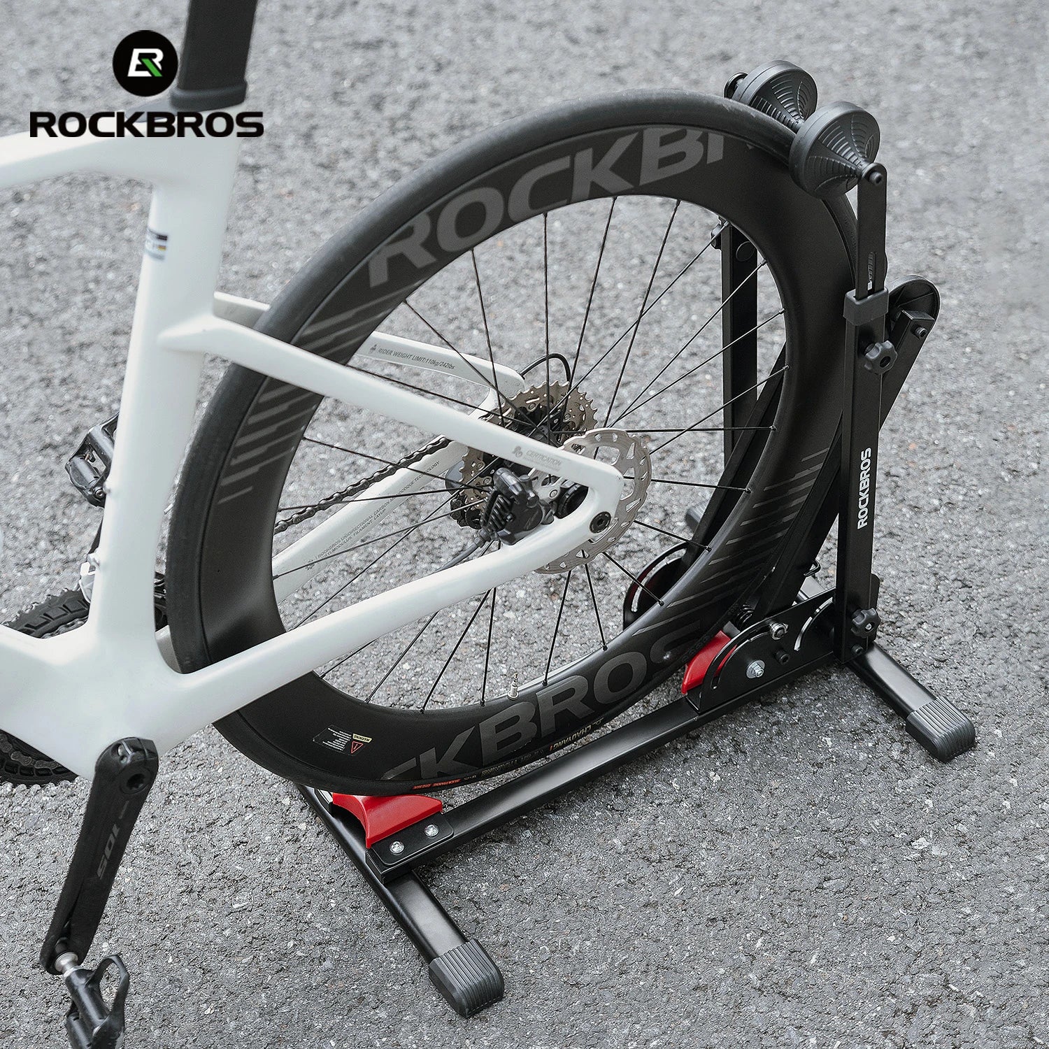 Bicycle on a stationary trainer with 'RockBros' branding on a gray surface