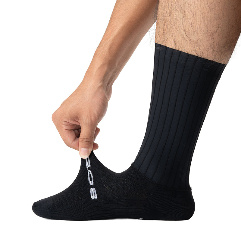 Person holding a black sock with a brand logo on a white background #color_Black Stripes - Gold Label