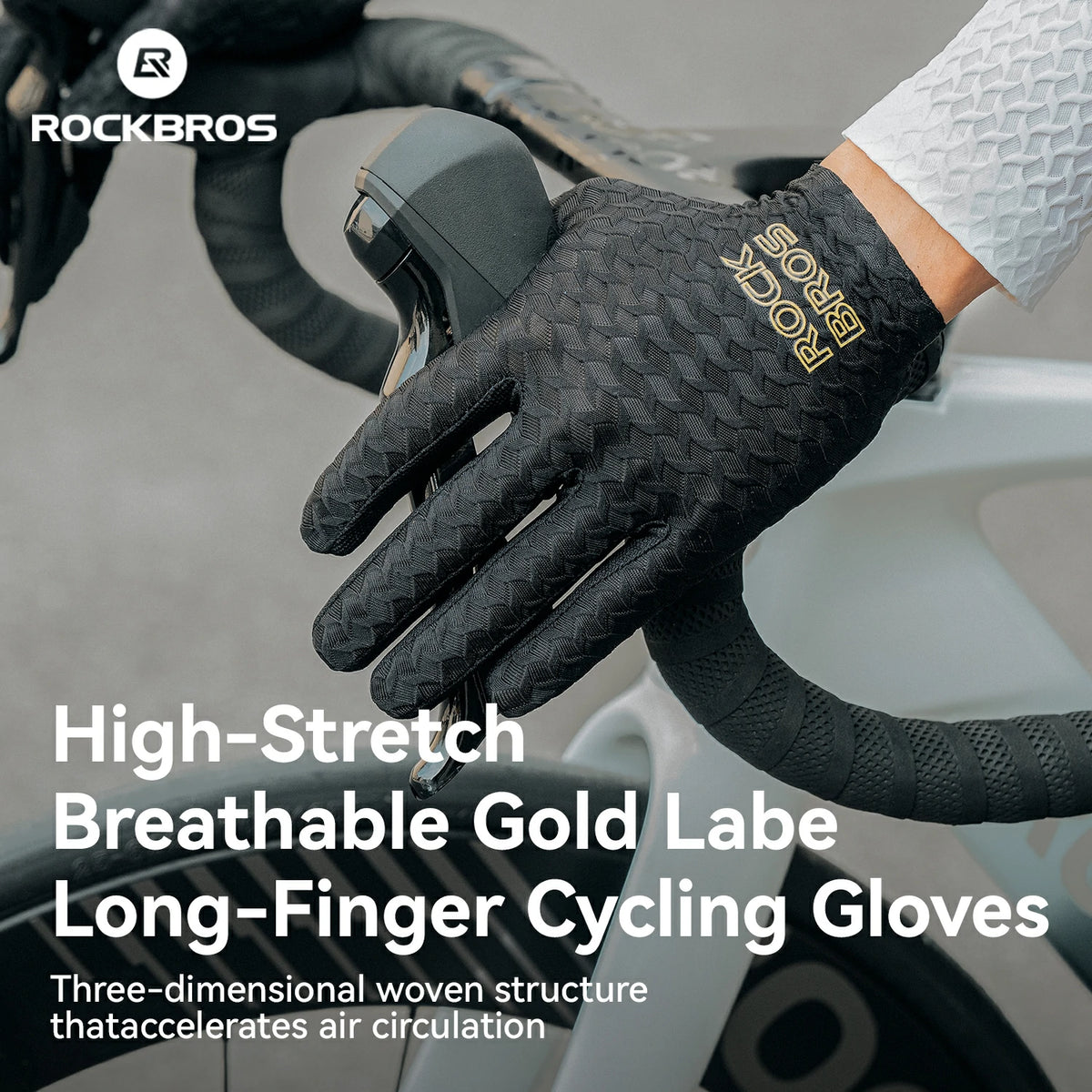 A close-up of a cyclist wearing a black Rockbros long-finger cycling glove with gold lettering, gripping a bicycle handlebar. The image includes promotional text highlighting the glove's high-stretch, breathable, and labe features.
