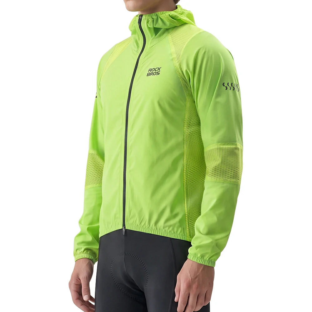 A man wearing a bright lime green RockBros hooded windbreaker jacket with black cycling shorts, shown from the neck down against a plain white background.