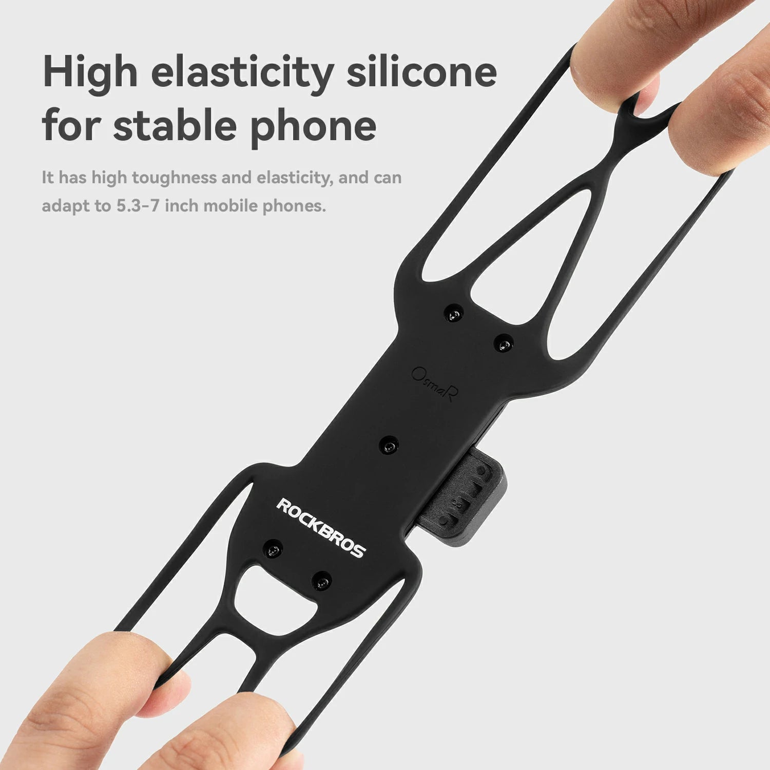 A close-up of a black silicone phone stabilizer grip being held by two hands against a light gray background, with promotional text on the left describing its high elasticity and phone adaptation.