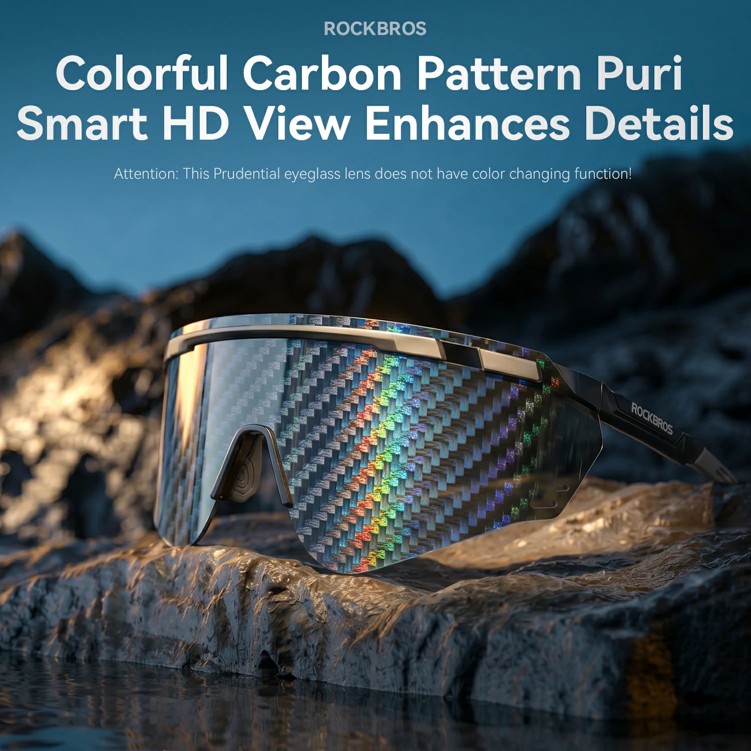 Rockbros eyeglasses with a colorful carbon pattern lens, resting on a rocky cliffside with a mountainous background under a blue sky.