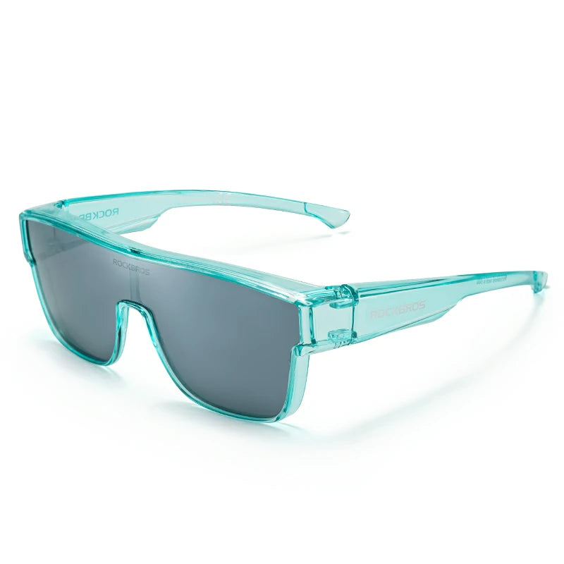 A pair of wraparound shield sunglasses with a translucent aqua frame and dark gray lenses, shown on a clean white background. #Color_Blue