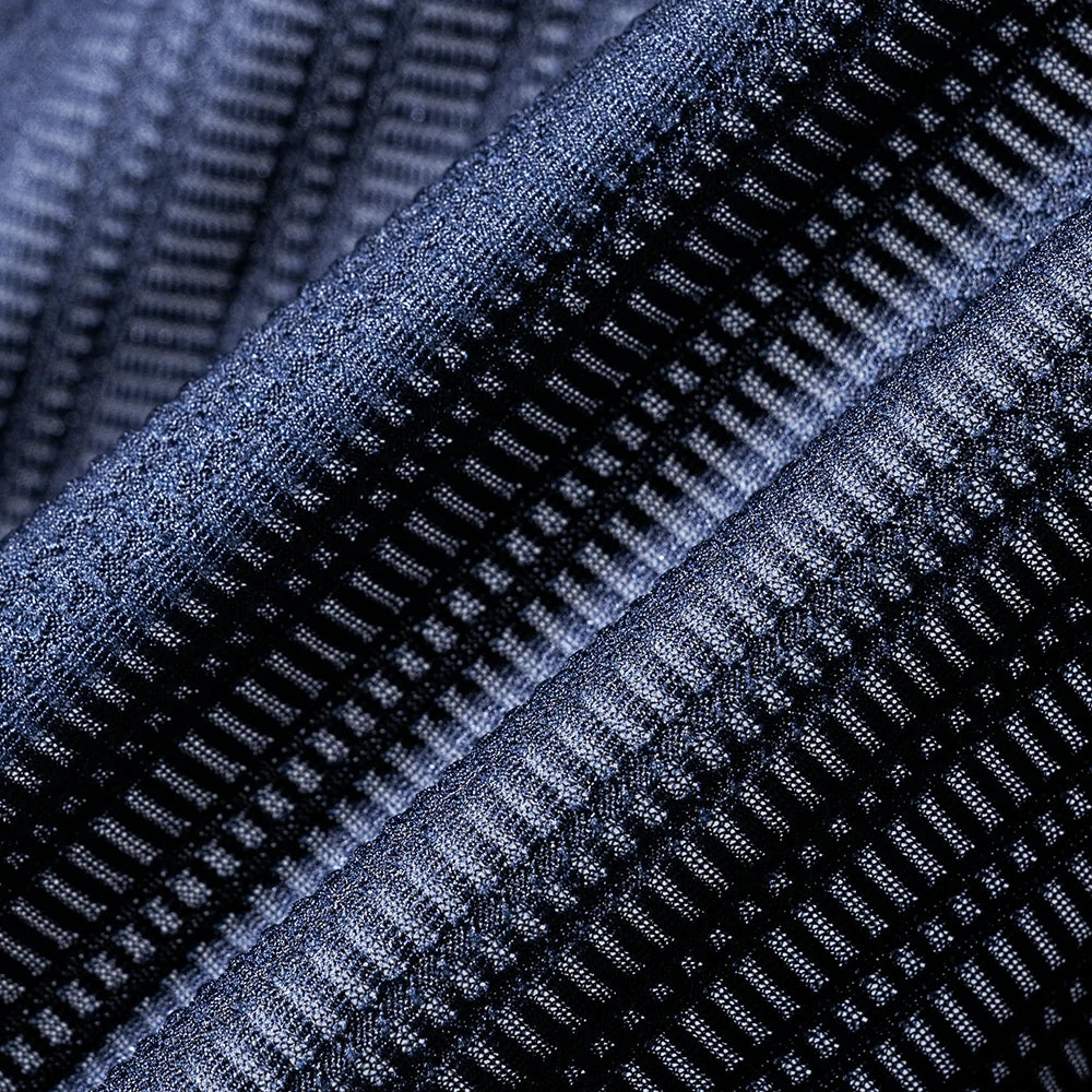 Close-up of textured blue fabric with a grid pattern