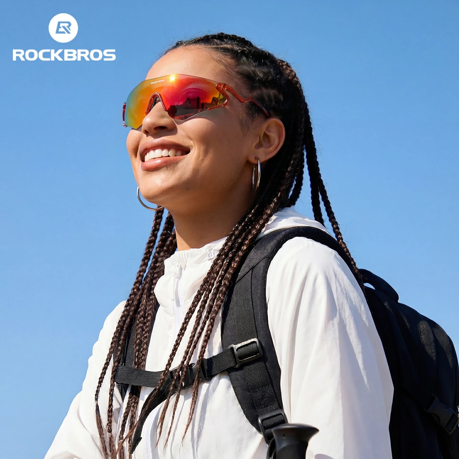 Woman wearing sunglasses and a backpack with a clear blue sky background, featuring the Rockbros brand. #Color_Red