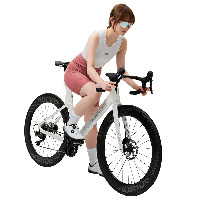 Woman sitting on a white bicycle with black tires on a white background #color_Pink