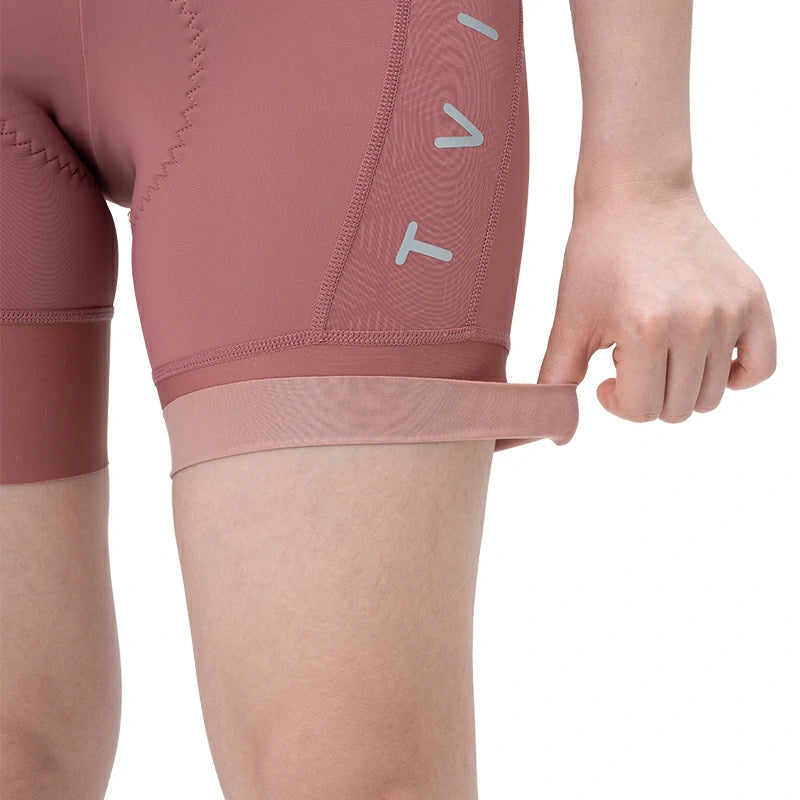 Close-up of pink athletic shorts with a brand logo on a white background