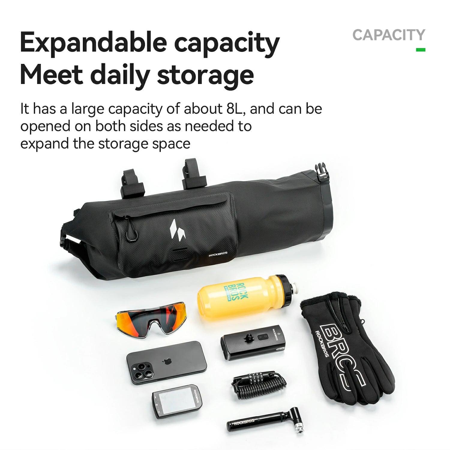 Black expandable storage bag with various items on a white background