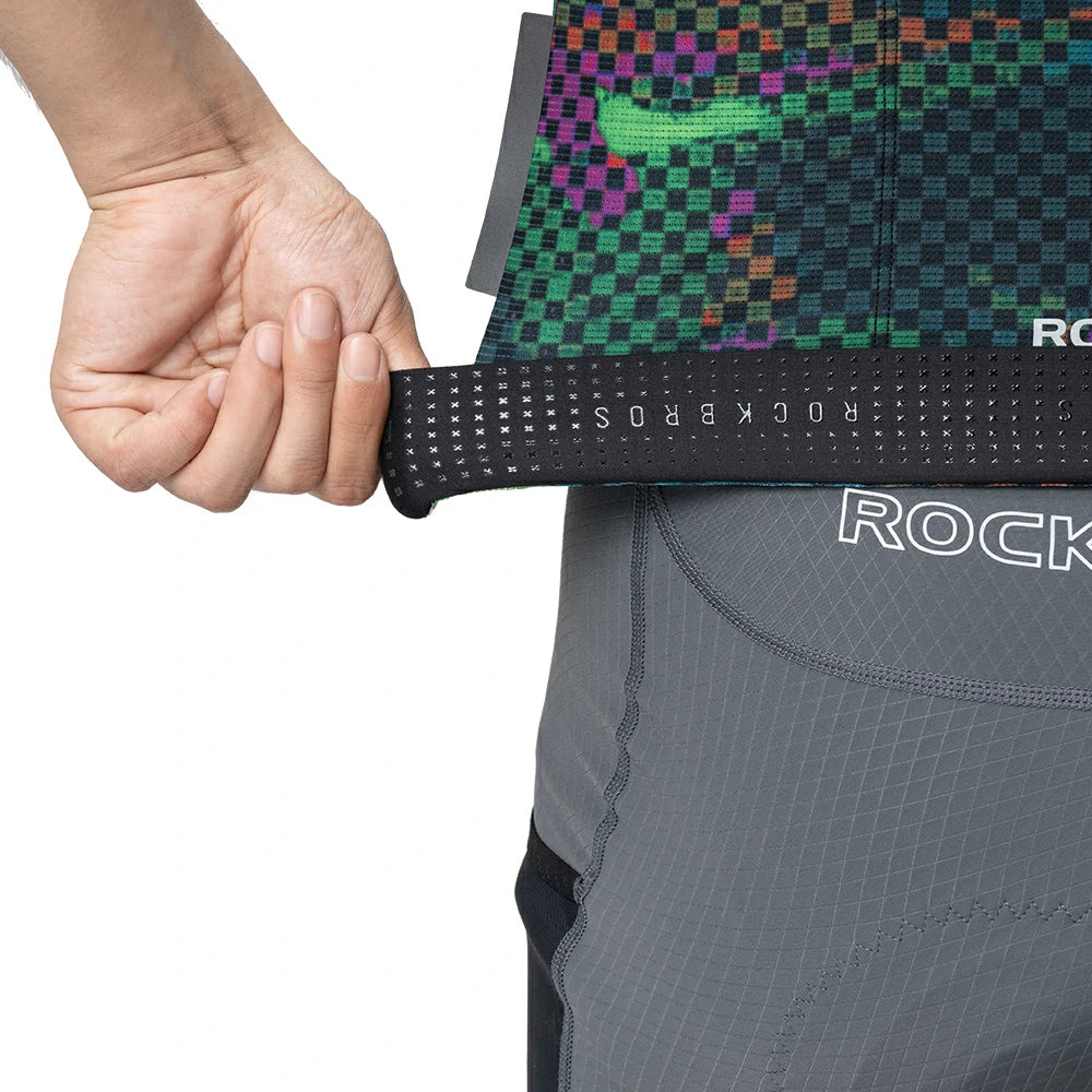 Person wearing a gray athletic outfit with a colorful patterned waistband, holding the waistband.